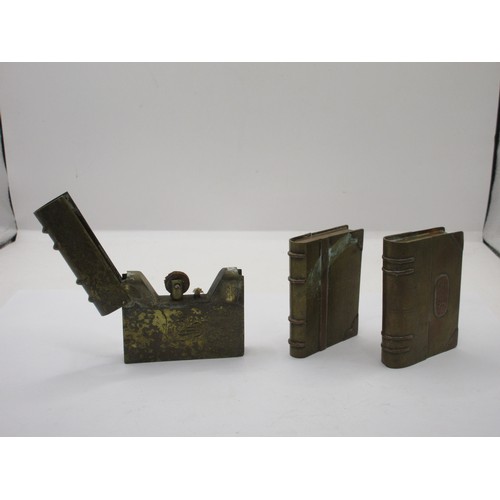 196 - Three WW1 trench art petrol lighters in the form of miniature books, made from pieces of scrap brass... 