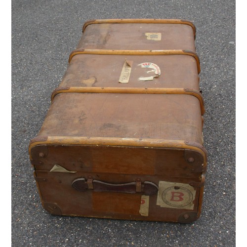 207 - A large antique trunk with wooden binding to exterior