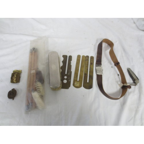 215 - An RN Submarines belt buckle, several pre-WW2 button slides, a Royal Engineers cap badge, a white me... 