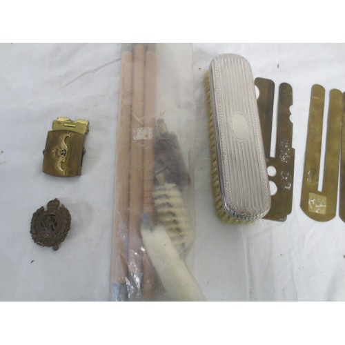 215 - An RN Submarines belt buckle, several pre-WW2 button slides, a Royal Engineers cap badge, a white me... 