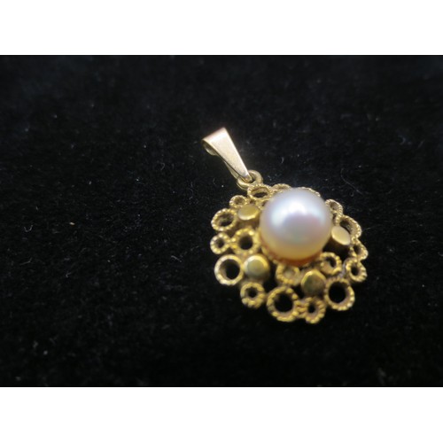 219 - A yellow metal (acid tests as 9 carat) pendant with a single pearl or simulated pearl mounted to cen... 