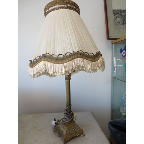236 - A brass columnal table lamp on scrolled feet under square base, with shade