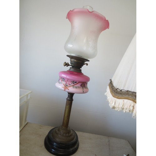 237 - A Corinithian columnal oil lamp with art nouveau floral decorated oil reservoir, with funnel and etc... 