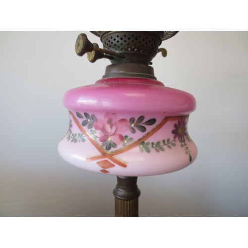 237 - A Corinithian columnal oil lamp with art nouveau floral decorated oil reservoir, with funnel and etc... 