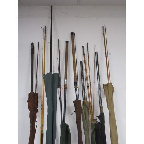 54 - A fishing rod bag containing nine rods and other items, a chair bag with folding seat and backpack s... 