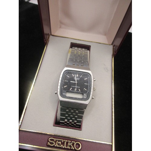 246 - A cased Seiko wristwatch with dual analogue and digital display, requires batteries at least, in ver... 