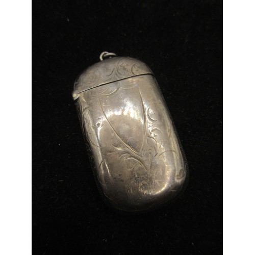 39 - A silver vesta with foliate engraving and vacant escutcheon to one side, gilt interior, marks for Bi... 