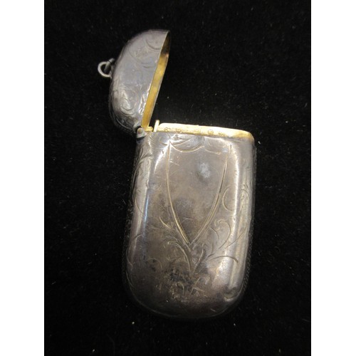 39 - A silver vesta with foliate engraving and vacant escutcheon to one side, gilt interior, marks for Bi... 