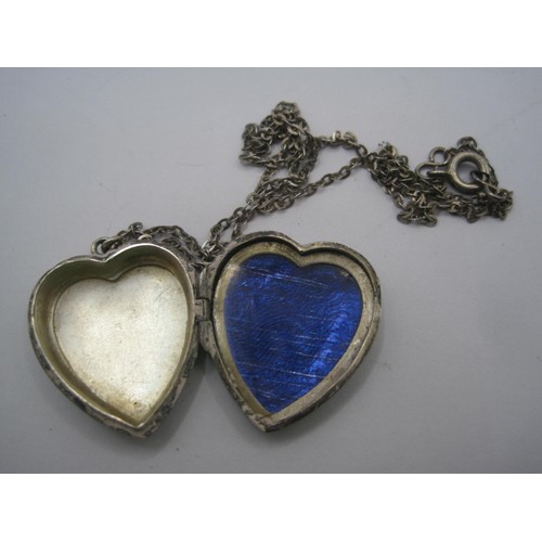 40 - A heart-shaped locket with foliate engraving to one side, stamped solid silver, with trace chain sta... 
