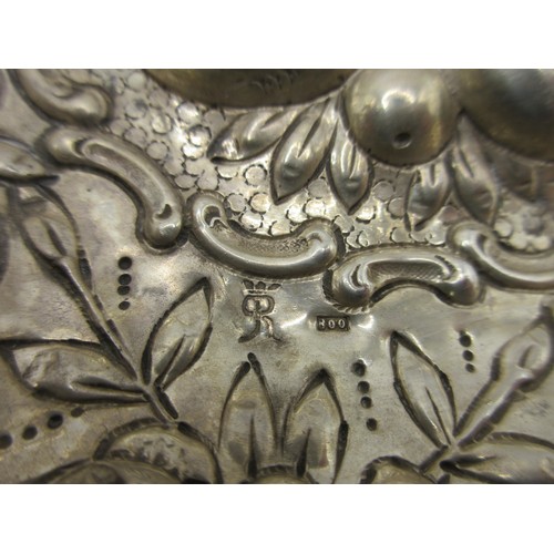 21 - An 800 white metal two-handled porringer type bowl, deeply embossed with fruit, flowers and shields.... 