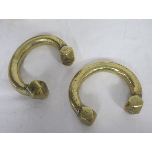 44 - Two heavy brass manillas, an engraved brass cigarette box marked Kinco, and a small brass bowl (diam... 