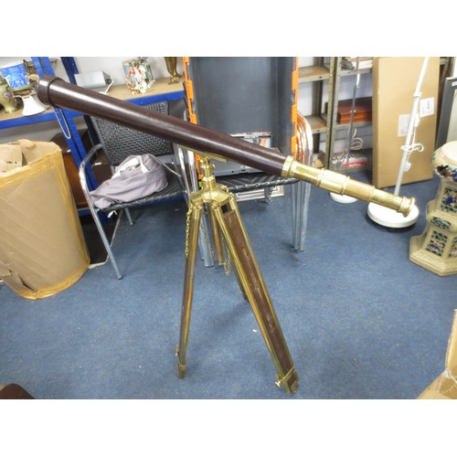 9 - A vintage leather bound brass telescope mounted upon a wood and brass tripod, with cover, in good ov... 