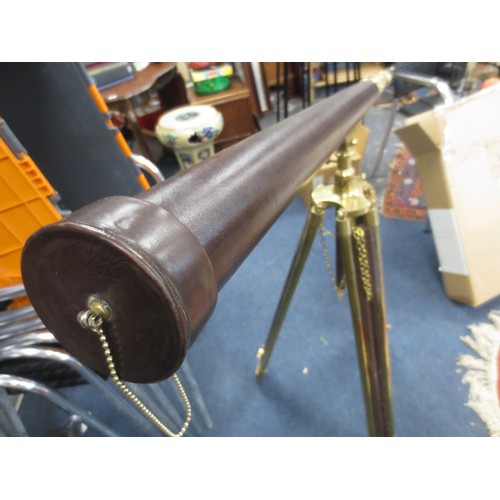 9 - A vintage leather bound brass telescope mounted upon a wood and brass tripod, with cover, in good ov... 