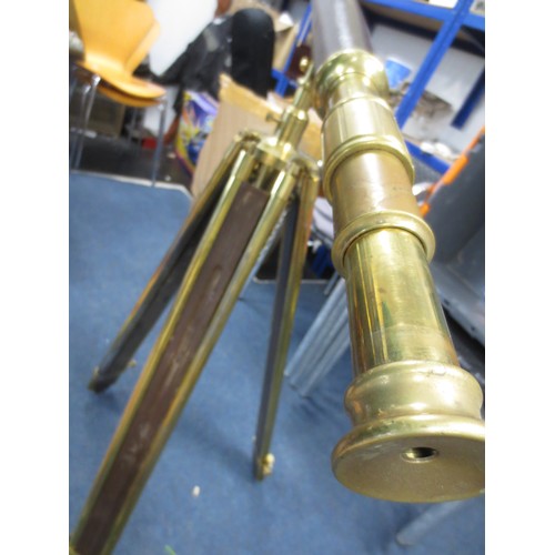 9 - A vintage leather bound brass telescope mounted upon a wood and brass tripod, with cover, in good ov... 