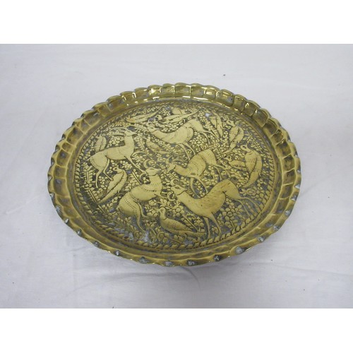 48 - An eastern circular brass tray engraved with lions and figures (diameter 43cm), a brass tray embosse... 