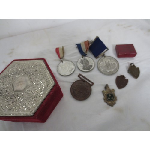 7 - A velvet box with white metal top containing an assortment of medals and fobs, including a sterling ... 