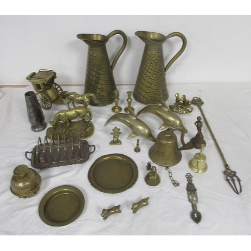 60 - Assorted brass and metal ware, including brass jugs, bells, dolphins, horse and carriage, toasting f... 