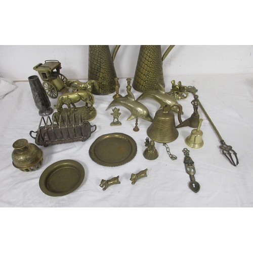 60 - Assorted brass and metal ware, including brass jugs, bells, dolphins, horse and carriage, toasting f... 
