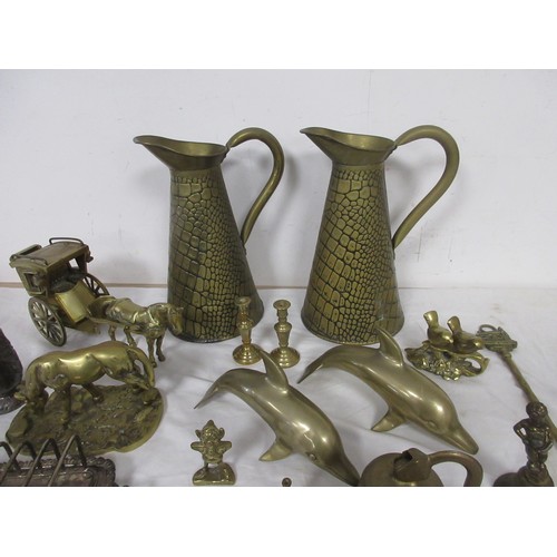 60 - Assorted brass and metal ware, including brass jugs, bells, dolphins, horse and carriage, toasting f... 