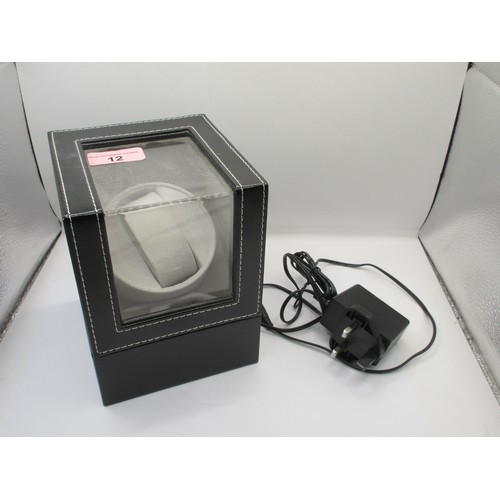 12 - An automatic watch winder, black leather effect finish and grey interior. With power adaptor