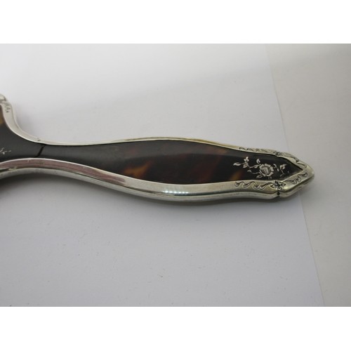 13 - An inlaid silver and tortoiseshell four-piece dressing table set comprising a clothes brush, two han... 