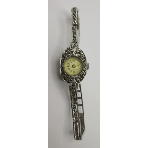 15 - A ladies silver cocktail wristwatch set with marcasite to the case and bracelet. The back of the cas... 