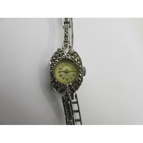 15 - A ladies silver cocktail wristwatch set with marcasite to the case and bracelet. The back of the cas... 