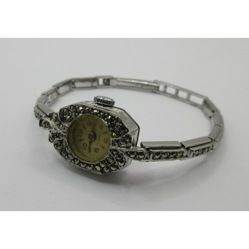 15 - A ladies silver cocktail wristwatch set with marcasite to the case and bracelet. The back of the cas... 