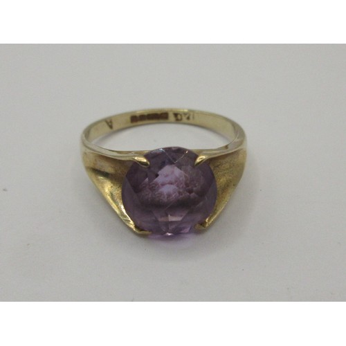 16 - A 9 carat gold ring set with a single faceted amethyst in a claw setting,  ring size J, stamped 375 ... 