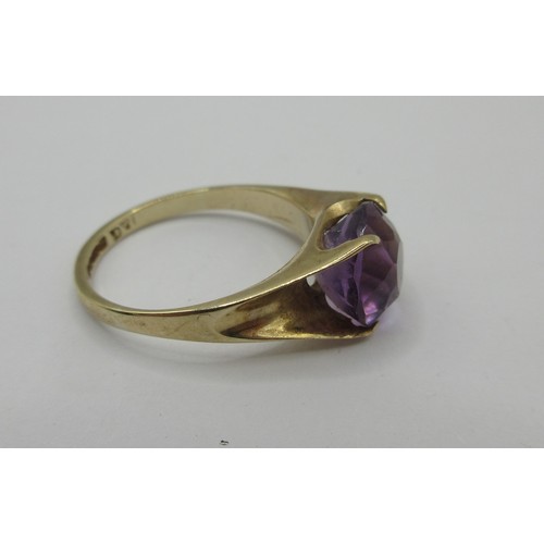 16 - A 9 carat gold ring set with a single faceted amethyst in a claw setting,  ring size J, stamped 375 ... 