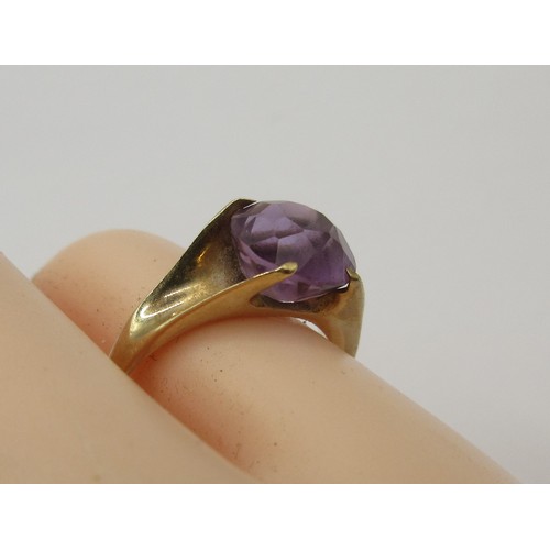 16 - A 9 carat gold ring set with a single faceted amethyst in a claw setting,  ring size J, stamped 375 ... 