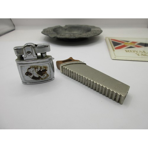 18 - A Calvin Hill cigarette lighter shaped as a saw, a Dragon Manufacturing Pacific cigarette lighter,  ... 