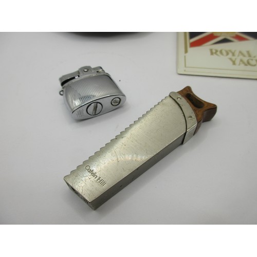 18 - A Calvin Hill cigarette lighter shaped as a saw, a Dragon Manufacturing Pacific cigarette lighter,  ... 