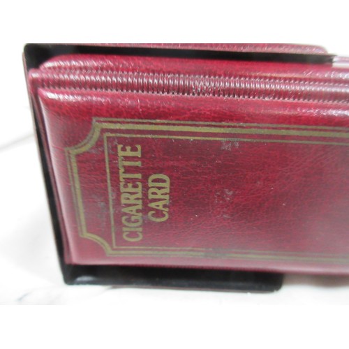 145 - A cigarette card collectors album in matching slip case containing a quantity of empty plastic card ... 