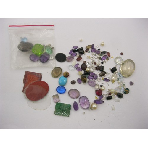 68 - A small bag of assorted precious and semi-precious stones of varying colours and sizes