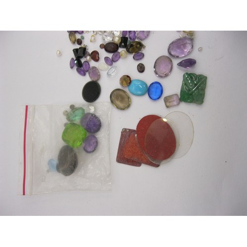 68 - A small bag of assorted precious and semi-precious stones of varying colours and sizes