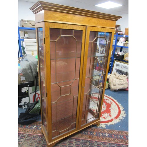 169 - A tall glazed display cabinet somewhat art deco in design, with glass shelves, key present, in very ... 