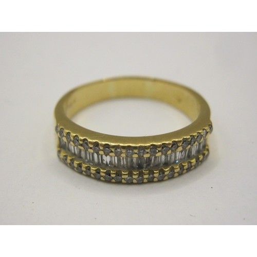 1 - An 18 carat gold ring with a distinctive setting of twenty baguette cut diamonds between two rows of... 