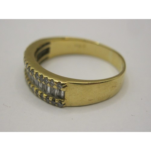 1 - An 18 carat gold ring with a distinctive setting of twenty baguette cut diamonds between two rows of... 