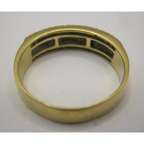 1 - An 18 carat gold ring with a distinctive setting of twenty baguette cut diamonds between two rows of... 