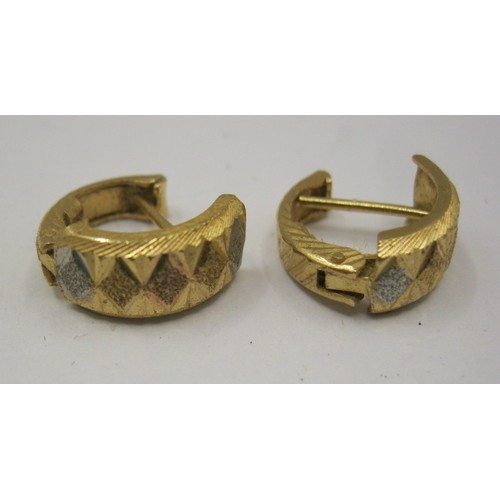 13 - A pair of 18 carat foreign gold earrings, of hinged open loop form, two-tone, with geometric facetin... 