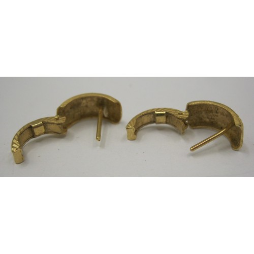 13 - A pair of 18 carat foreign gold earrings, of hinged open loop form, two-tone, with geometric facetin... 