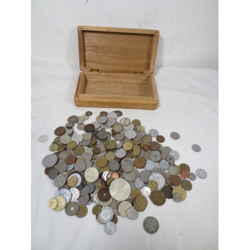 53 - Assorted world coins contained in a wooden box including some silver