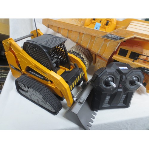 32 - Two remote control industrial vehicles a Front loader and a dumper truck.
Both look in good order th... 