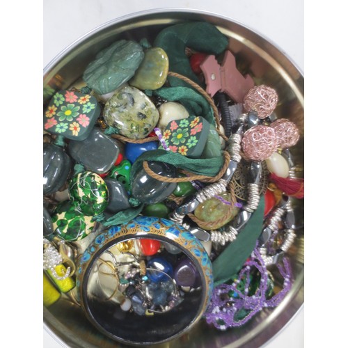 42 - A tin of costume jewellery large beaded necklaces