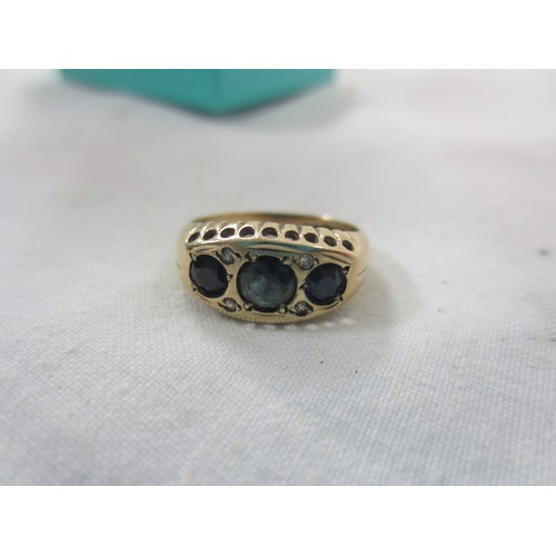 59 - A 9 carat gold ring set with red stones, likely garnets, approx weight 2.2g, ring size K
