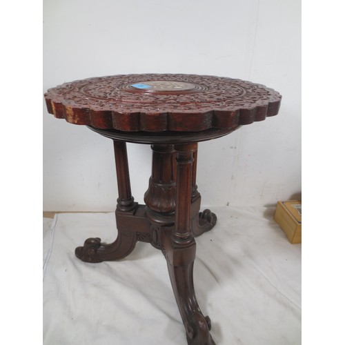 28 - A Liberty Style carved occasional/wine  table with tri feet .
One foot has had a vintage repair as p... 