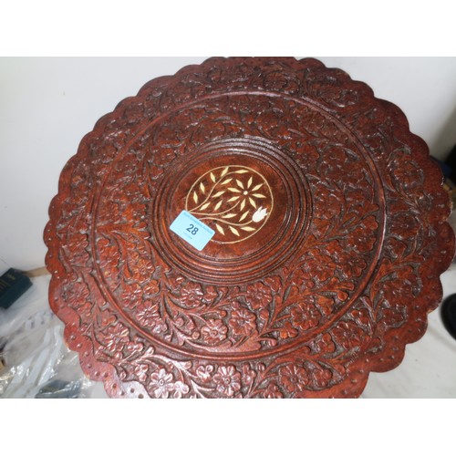 28 - A Liberty Style carved occasional/wine  table with tri feet .
One foot has had a vintage repair as p... 