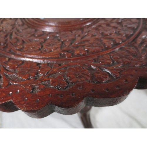 28 - A Liberty Style carved occasional/wine  table with tri feet .
One foot has had a vintage repair as p... 