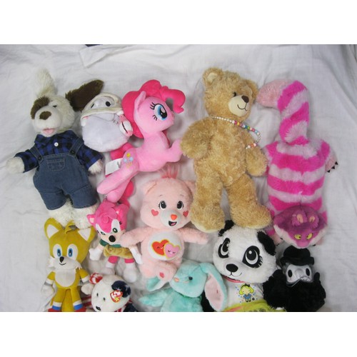 37 - A bag of assorted plush toys, including a Care Bear, a Build-a-Bear, and a Reesee My Little Pony